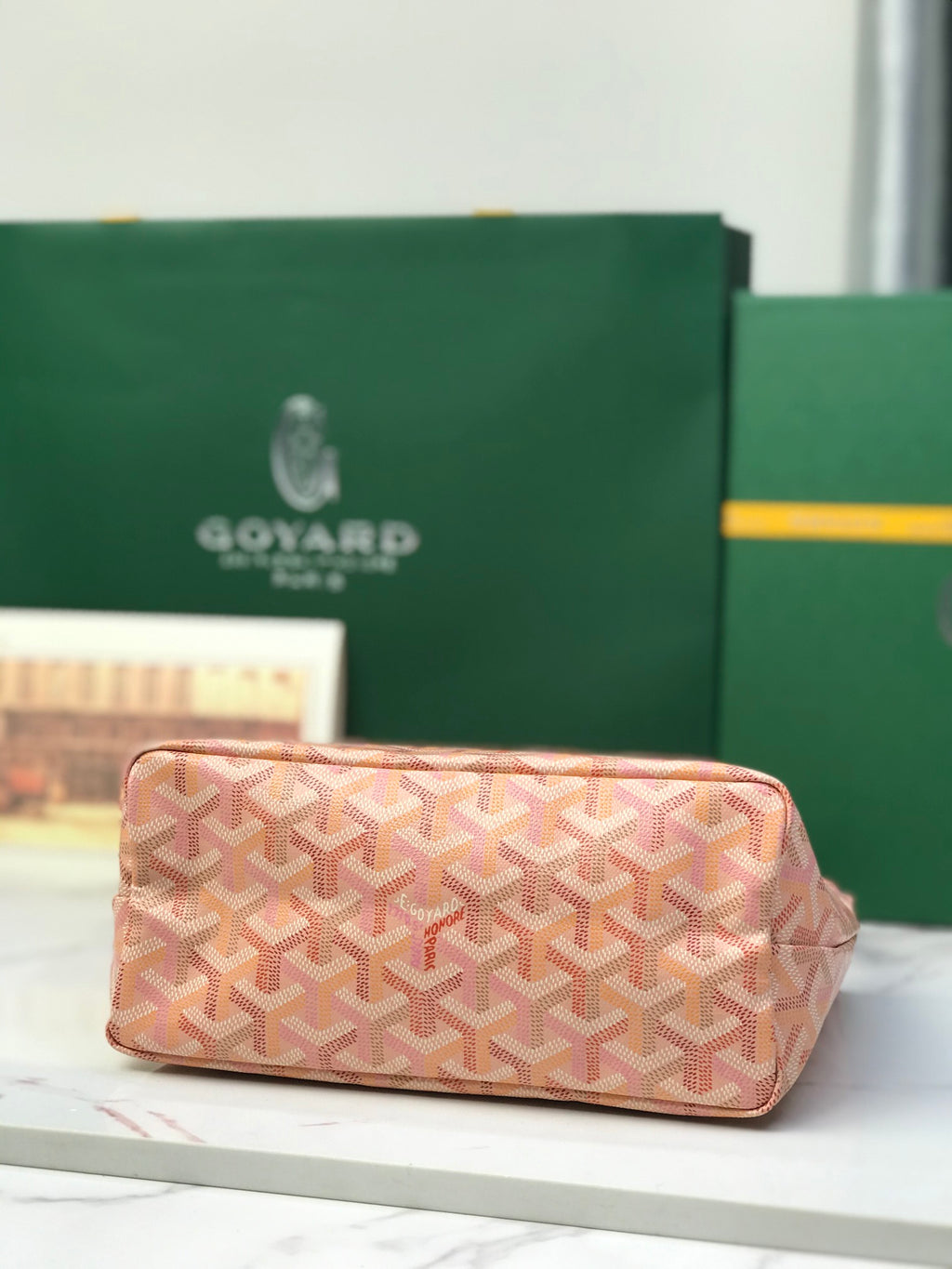 Pink Goyard-style canvas rectangular clutch with woven pattern and front pocket