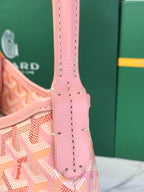Pink leather-and-canvas bag handle with side hardware and stitched seams