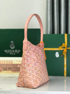 Pink Goyard-style canvas handbag with top handle, front pocket, and leather trim