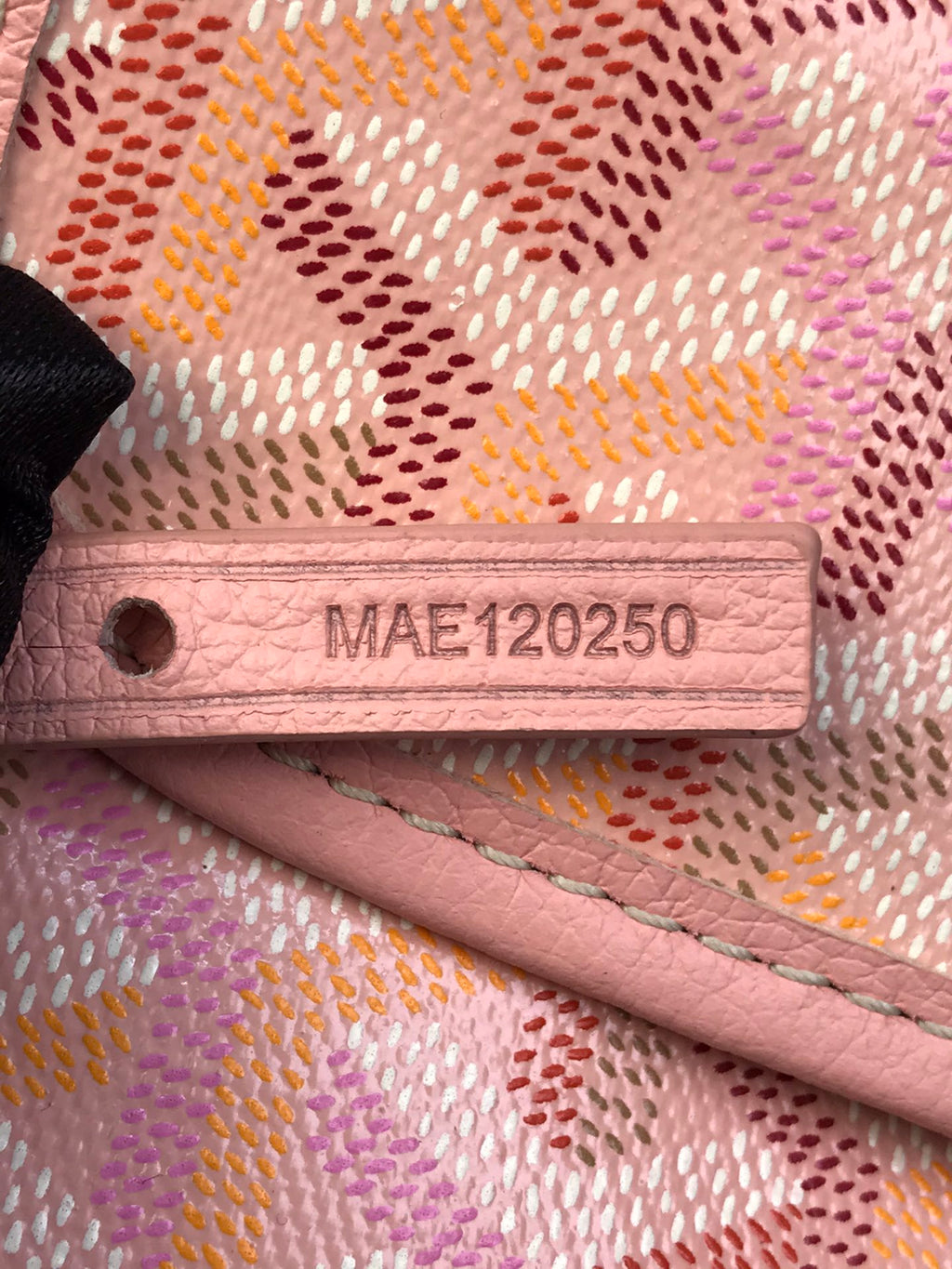 Pink bag fabric with MAE120250 serial label and stitched edge detail