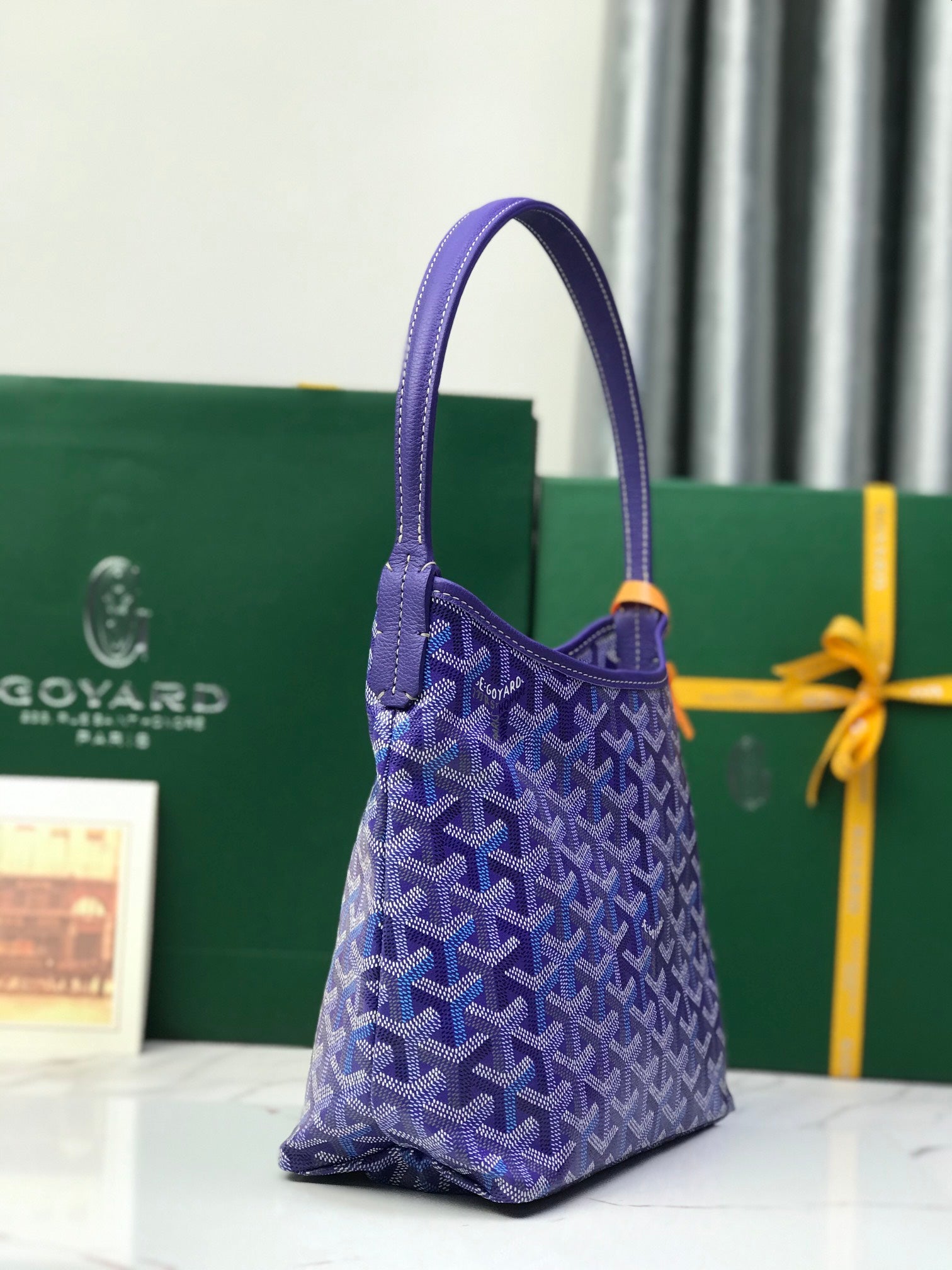 Purple patterned Goyard tote bag shown upright with top handles and flap