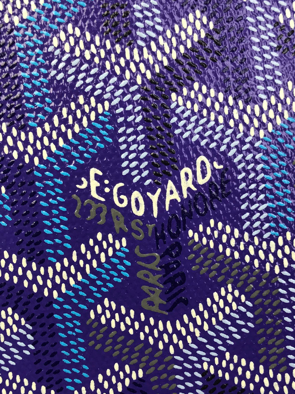 Close-up of purple Goyard patterned fabric with 'GOYARD' lettering