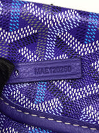 Purple leather tab with embossed code on Goyard patterned bag flap
