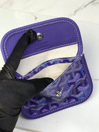 Goyard bag interior with purple lining, open top, and snap hardware