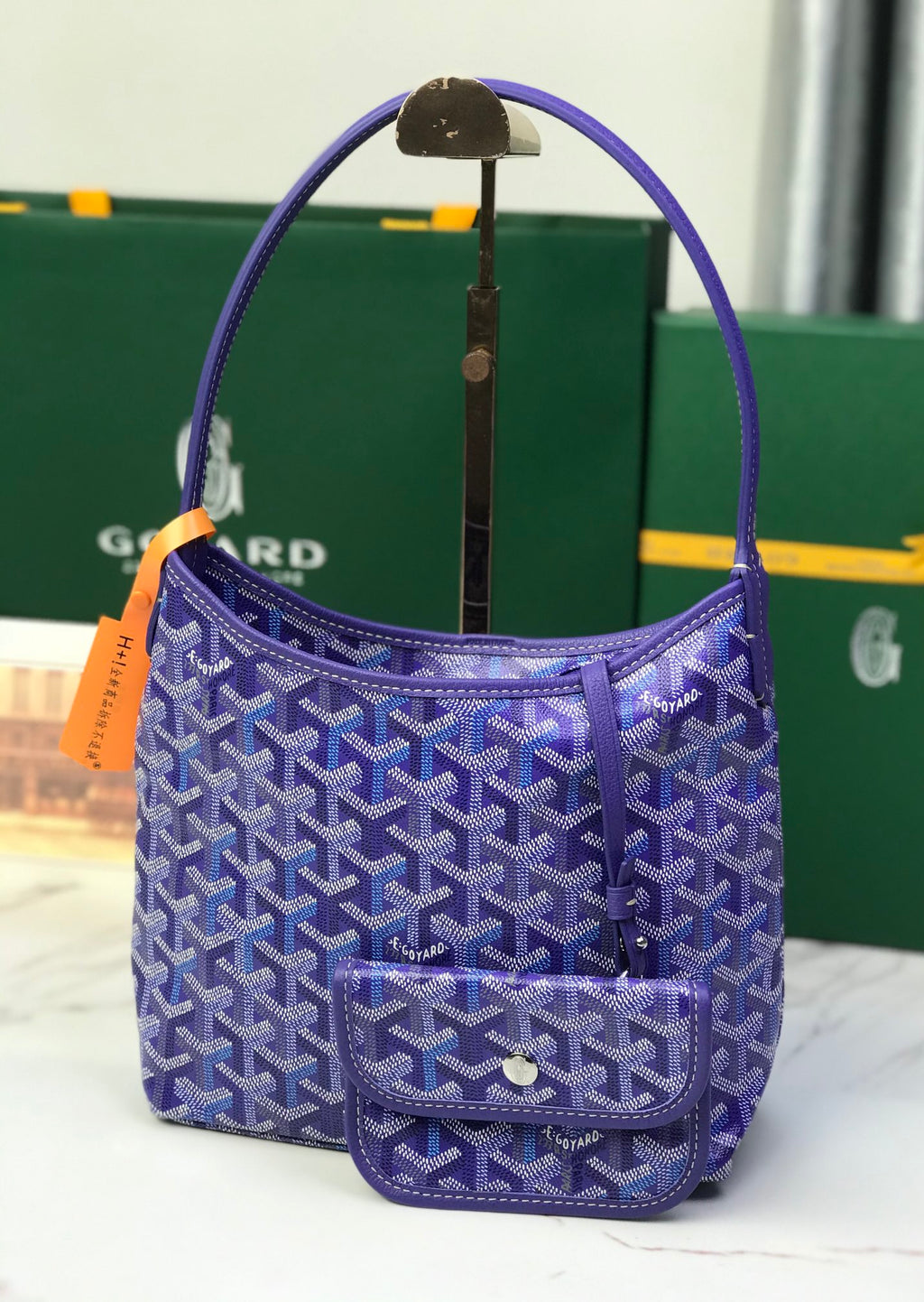 Purple patterned Goyard hobo bag with side handle strap and front flap pocket