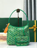 Green Goyard tote bag with structured handle and front flap pocket.