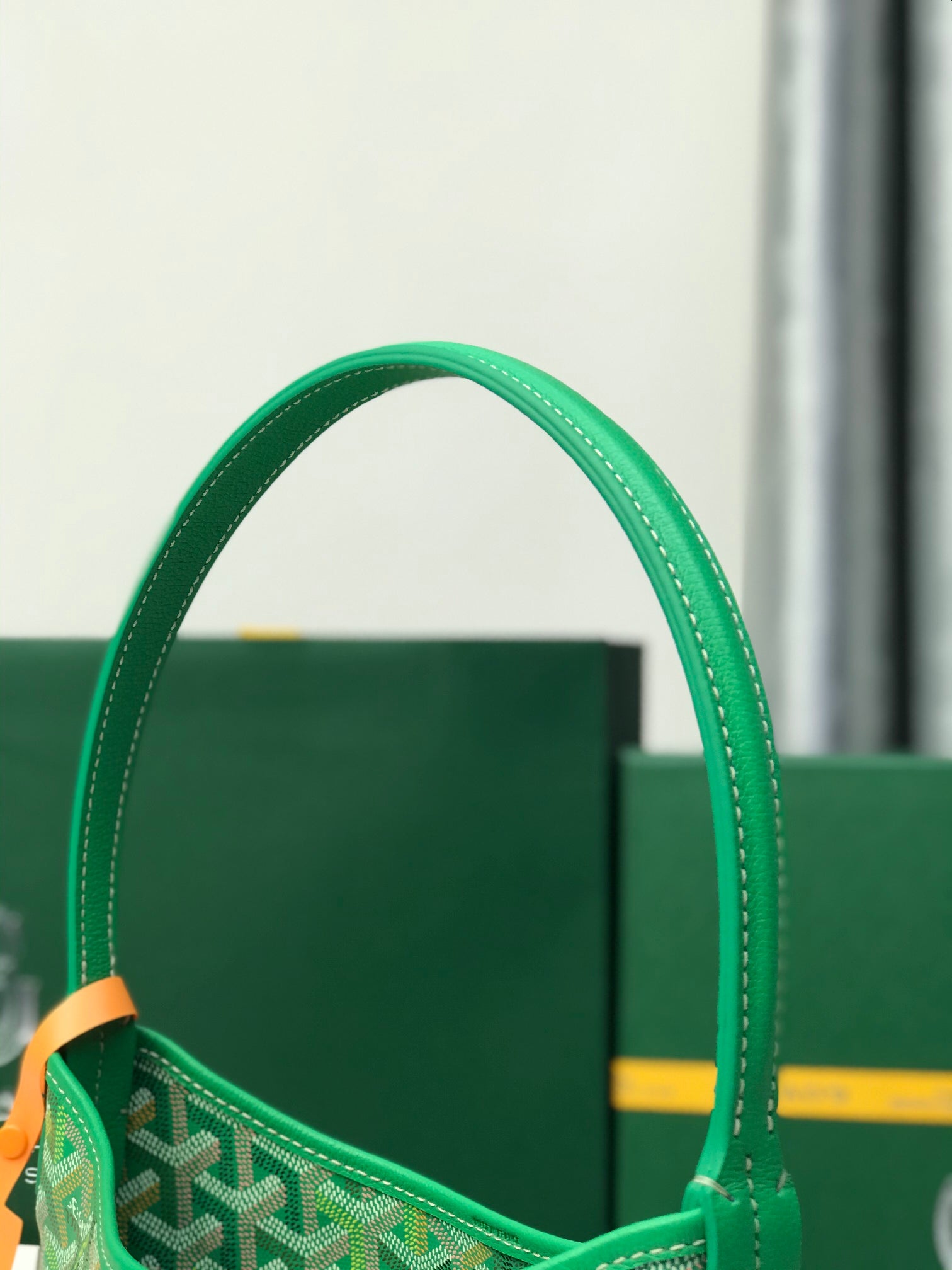 Green Goyard tote bag handle and top opening with monogram fabric detail.