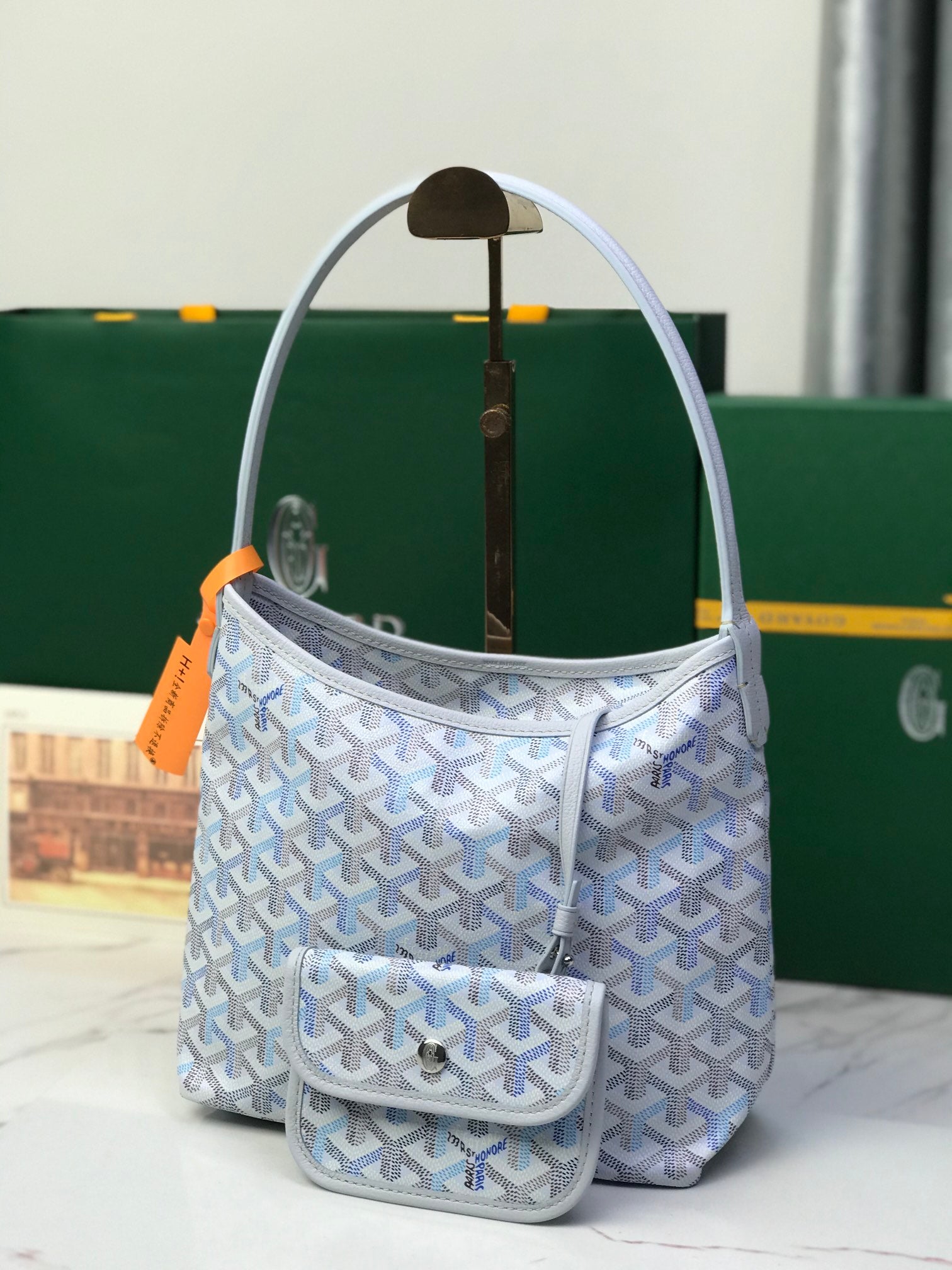 Goyard small bucket bag with front flap pocket and light blue Goyardine pattern
