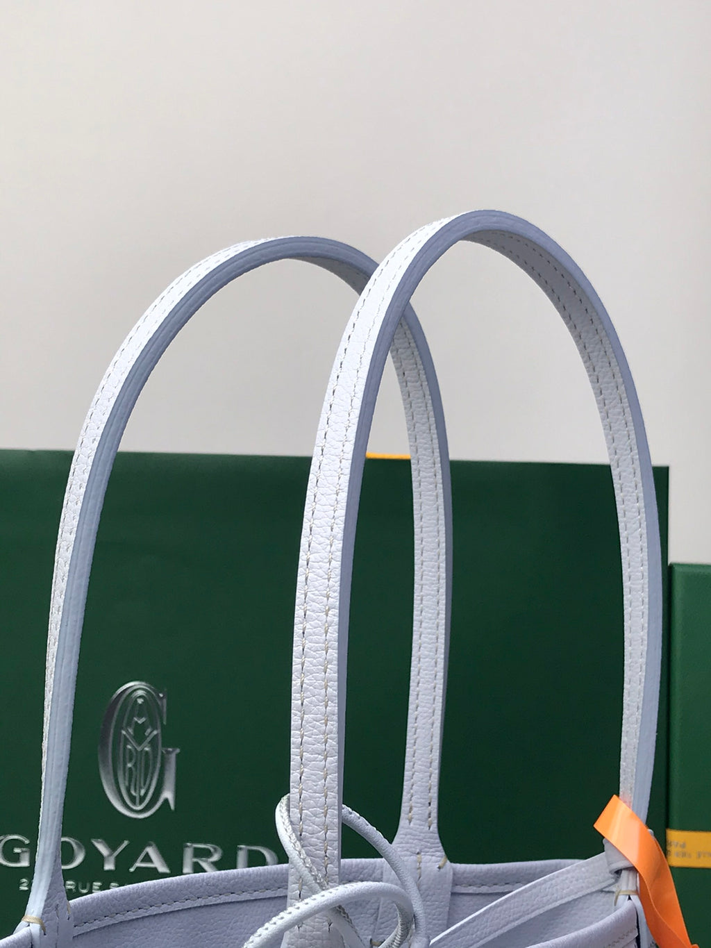 Goyard tote bag handles and structured top opening with patterned body