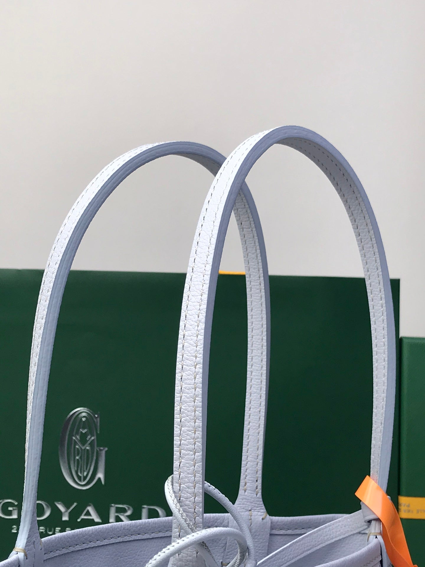 Goyard tote bag handles and structured top opening with patterned body