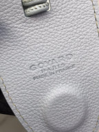 Goyard logo stamp on white leather bag panel with gold edge stitching