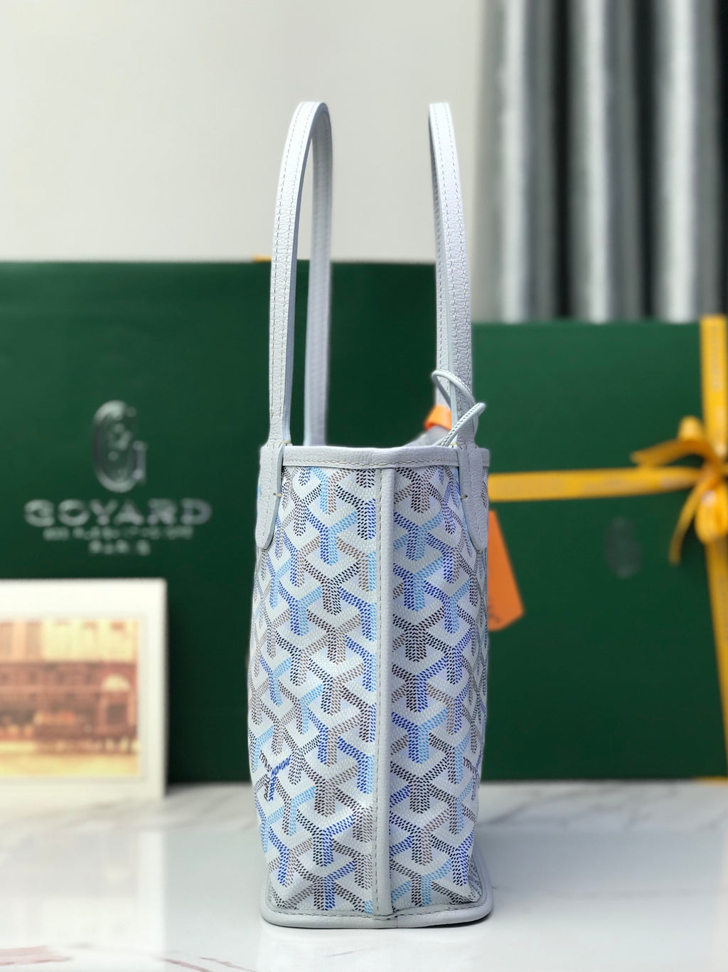 Goyard vertical tote bag with two handles and adjustable strap pouch detail