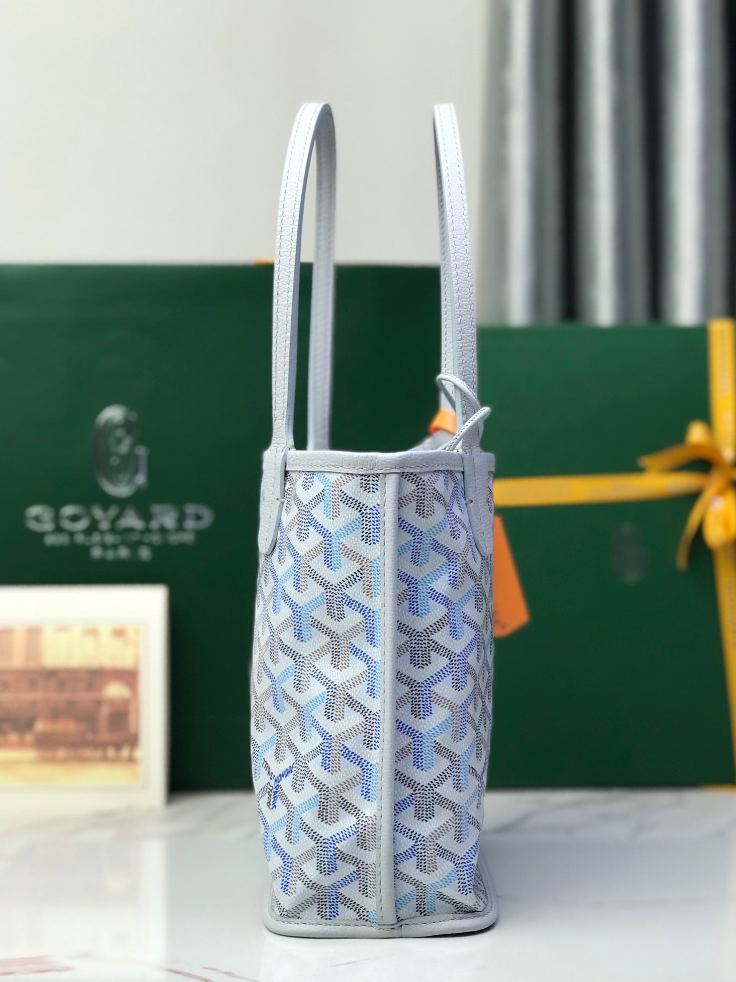 Goyard vertical tote bag with two handles and adjustable strap pouch detail