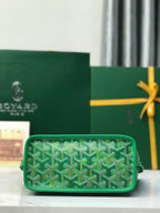 Green wristlet bag with textured Goyardine pattern and zipper closure