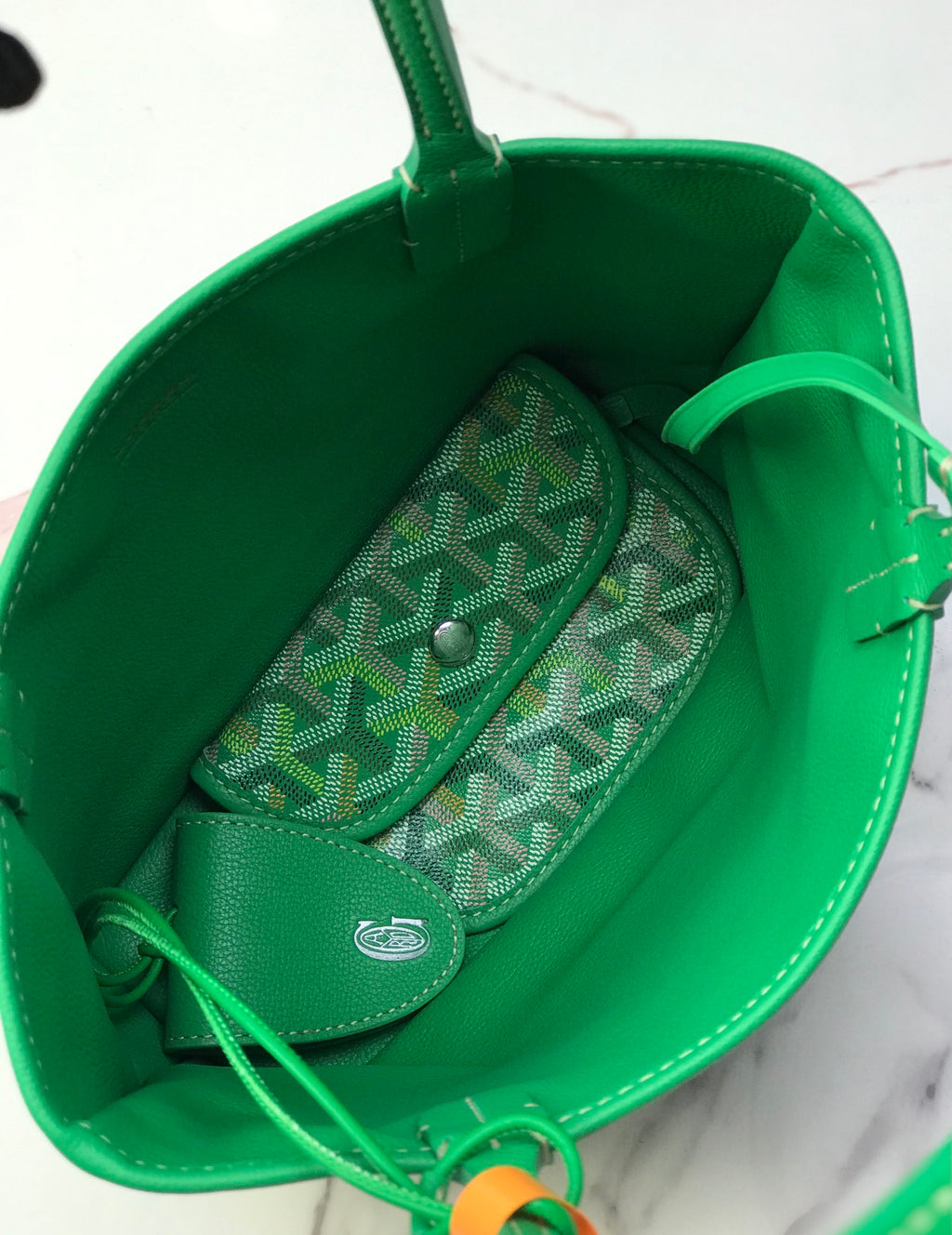 Green tote bag interior with patterned zip pocket and leather lining