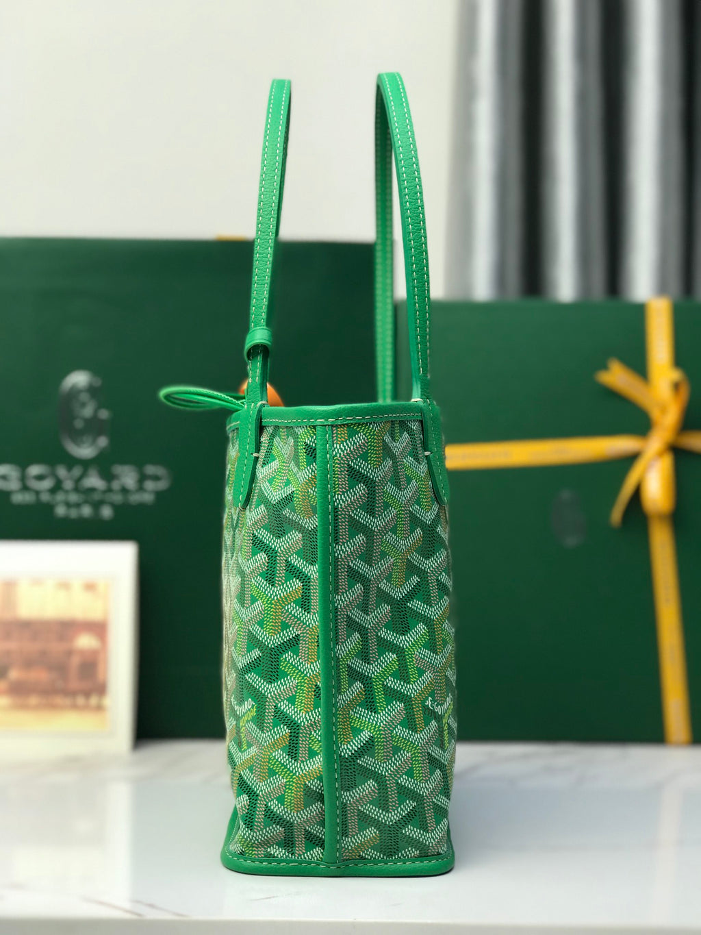 Green vertical tote bag with textured pattern, long handles, and side pocket