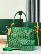 Green Goyard tote bag with textured pattern, top handles, and front pouch