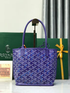 Goyard purple monogram tote bag with structured top handles and charm