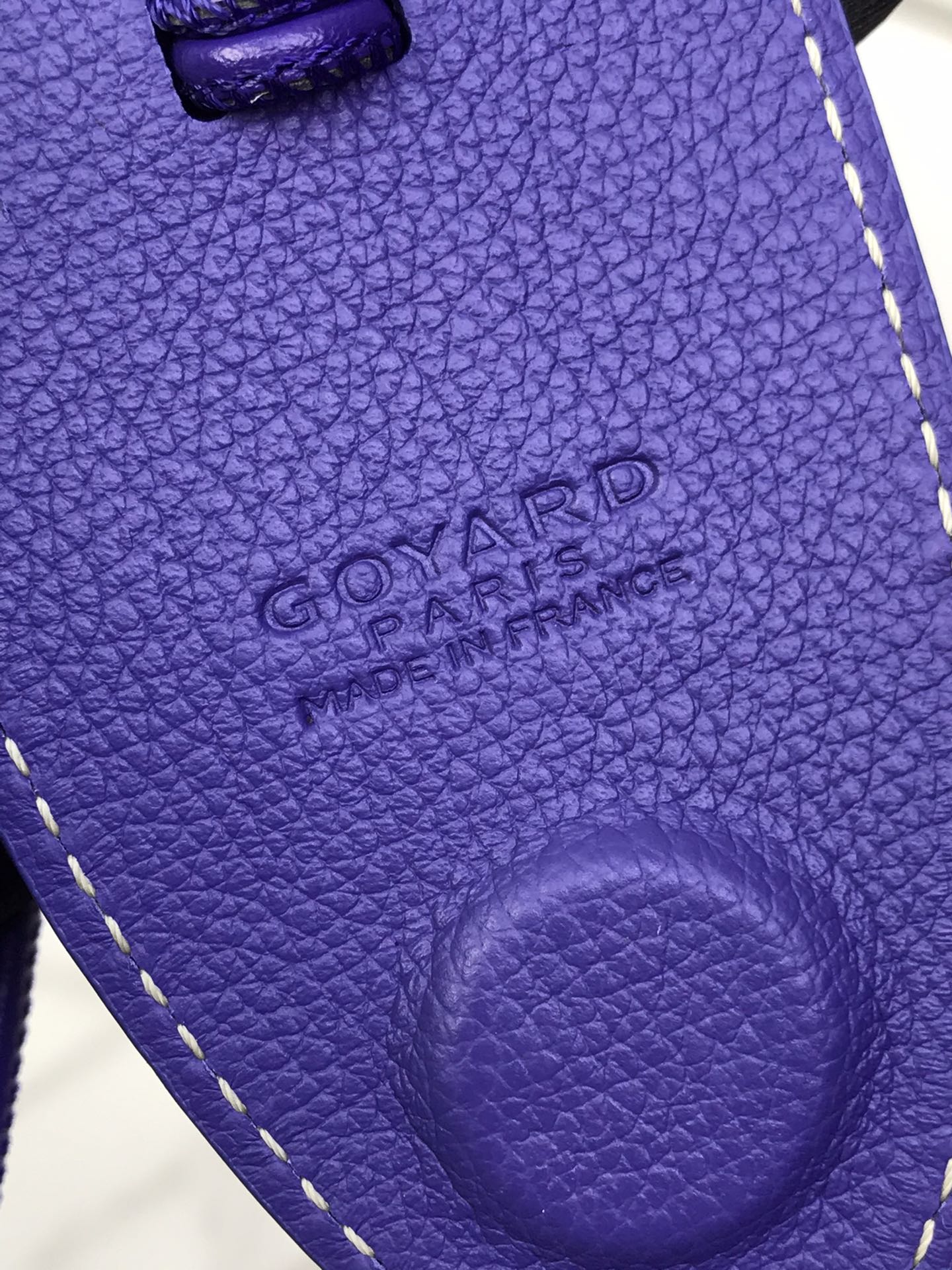 Goyard purple leather tote panel with embossed logo and curved pocket detail
