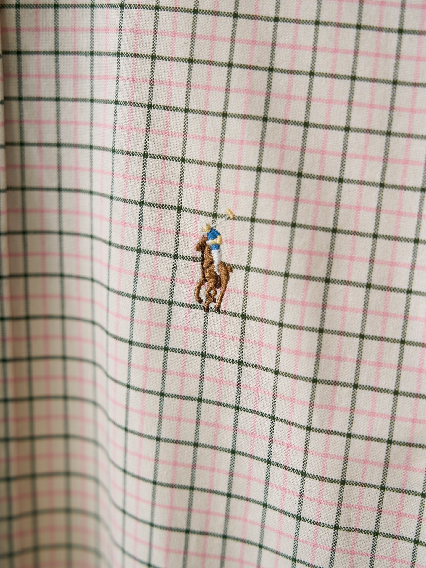 Ralph Lauren plaid shirt fabric close-up with small embroidered logo detail