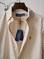 Ralph Lauren plaid button-up shirt with spread collar and brand label at neckline