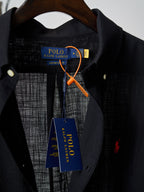 Black button-up shirt neckline with collar and visible inner brand tag