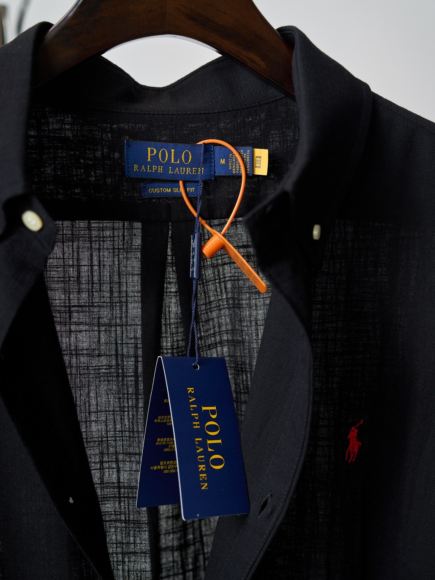 Black button-up shirt neckline with collar and visible inner brand tag