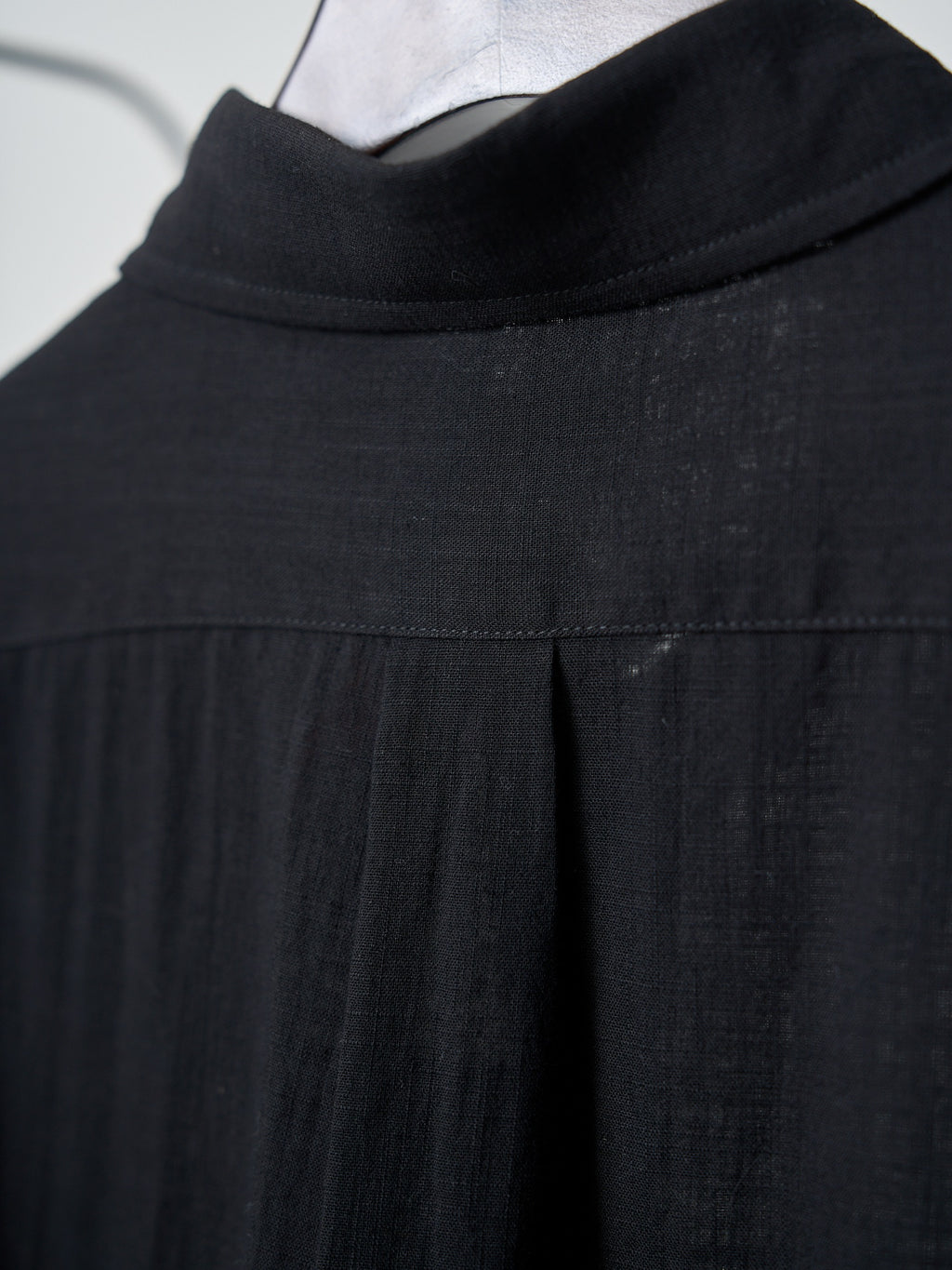Black button-up shirt collar and yoke seam detail