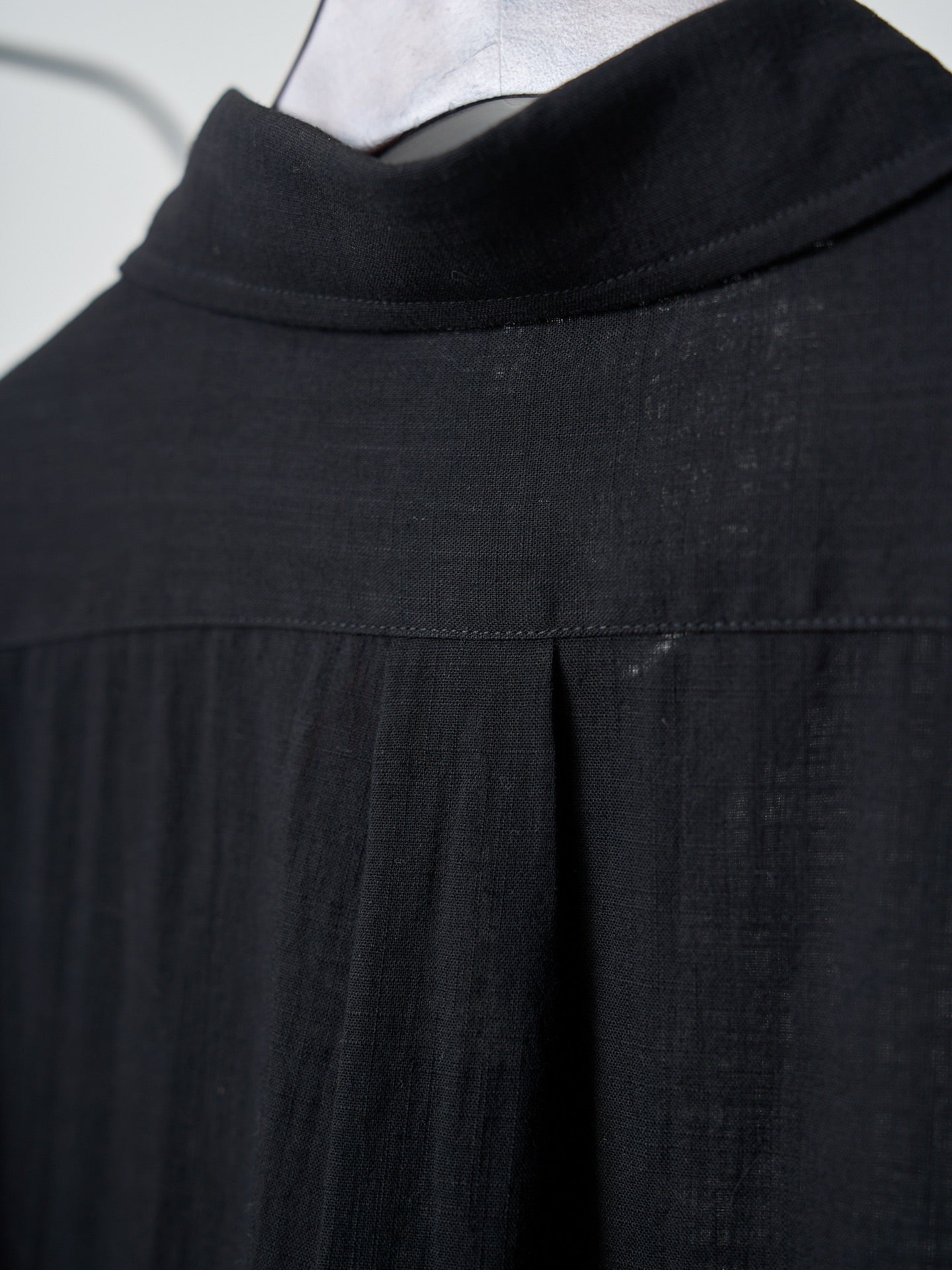 Black button-up shirt collar and yoke seam detail