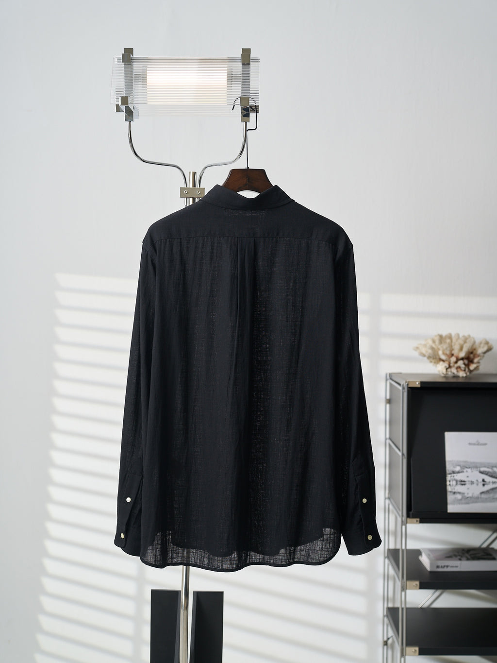 Black button-up shirt, back view with curved yoke and button placket