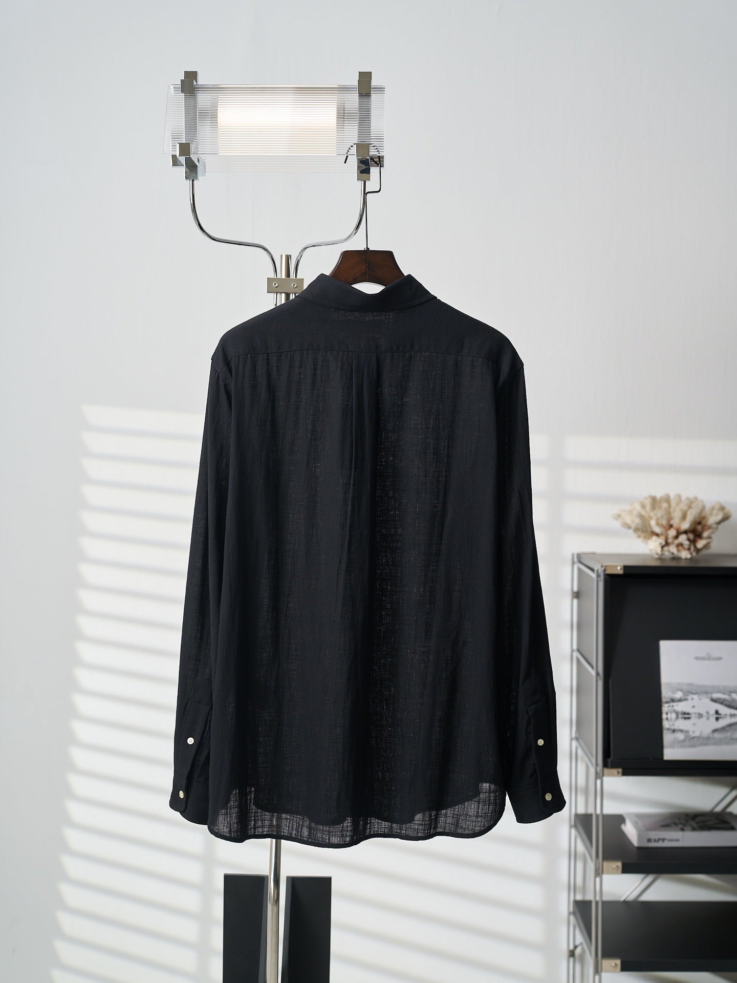 Black button-up shirt, back view with curved yoke and button placket