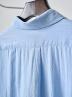 Light blue button-up shirt with spread collar and shoulder yoke seam