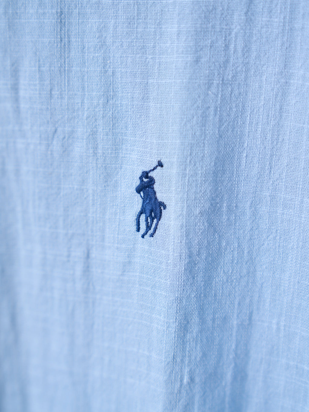 Light blue fabric with small navy pony logo on the chest