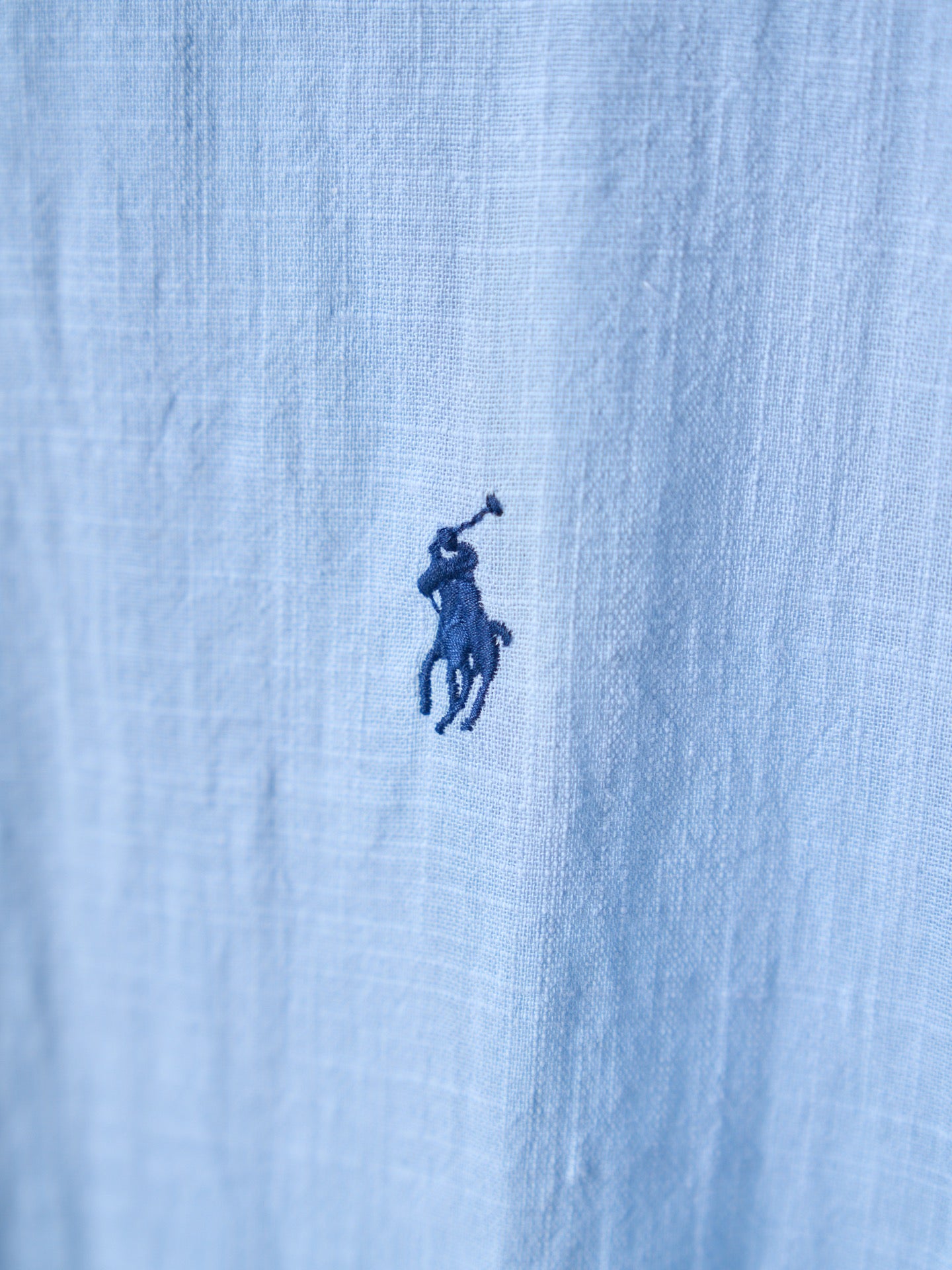 Light blue fabric with small navy pony logo on the chest
