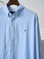 Light blue button-up shirt with small chest pony logo and long sleeves