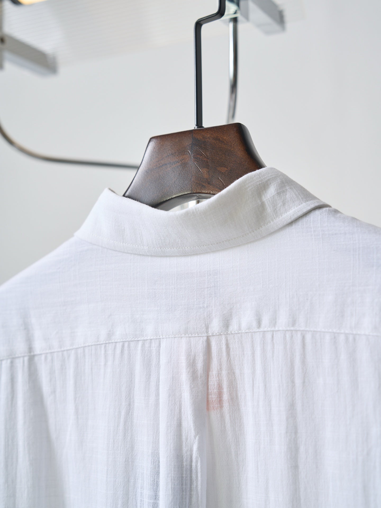 White button-up shirt with stand collar and top button placket