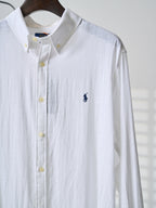 White button-up shirt with navy polo player logo, yellow button placket