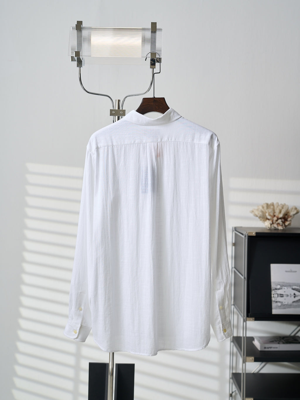 White button-up shirt, long sleeves, button front; no logo visible