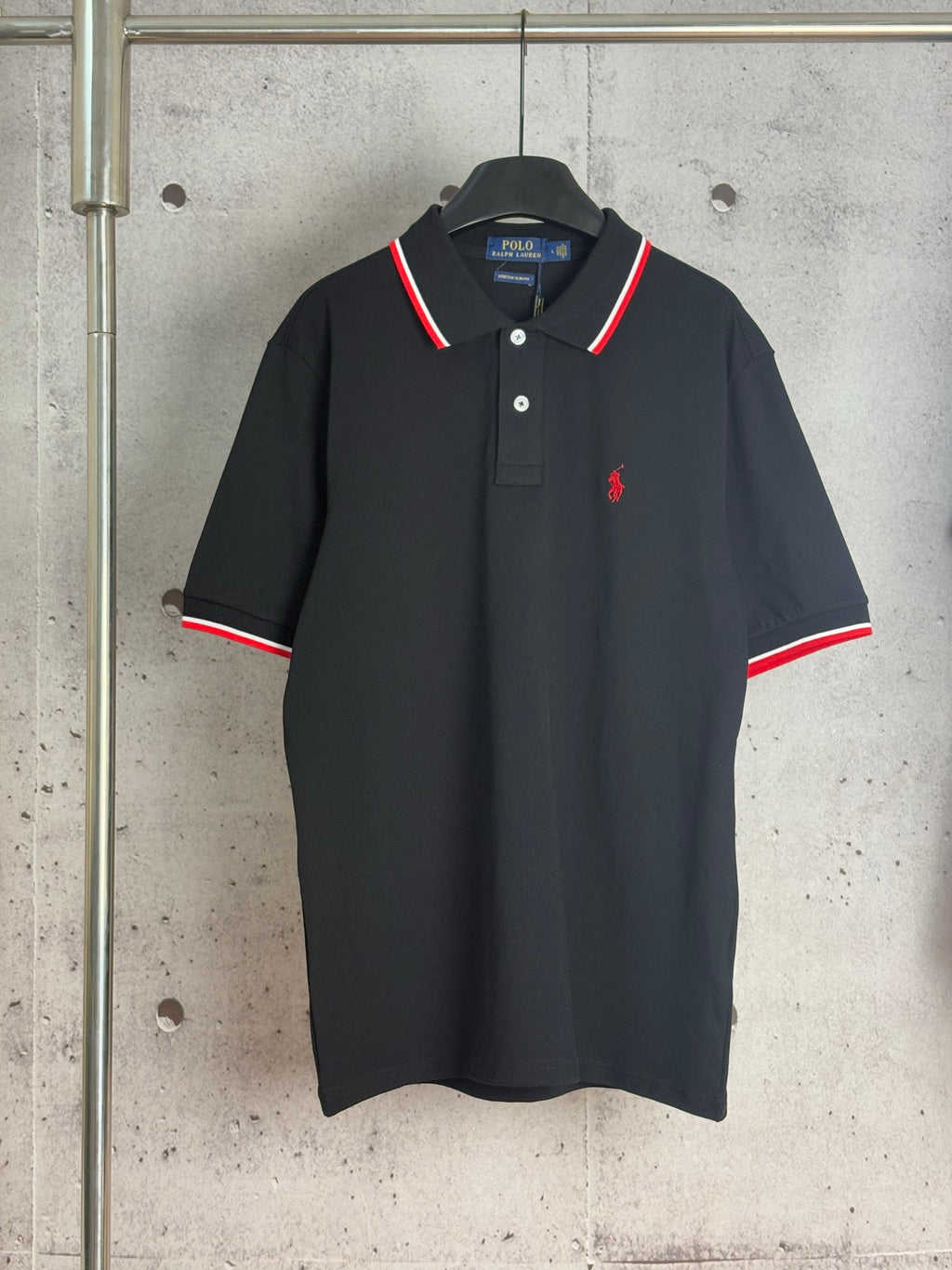 Black Polo Ralph Lauren polo shirt with red and white striped collar