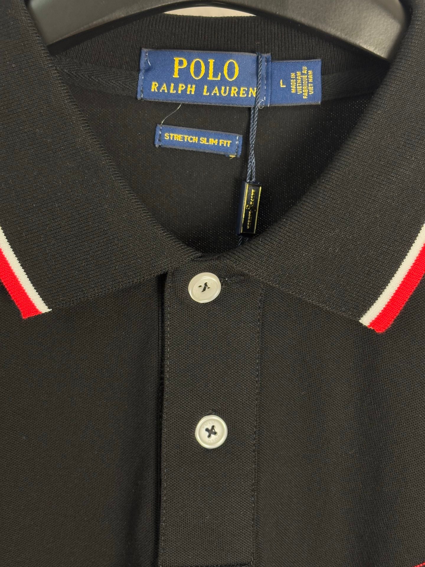 Black polo shirt collar and button placket with red and white trim