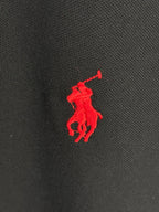 Red Polo pony logo on black textured polo fabric