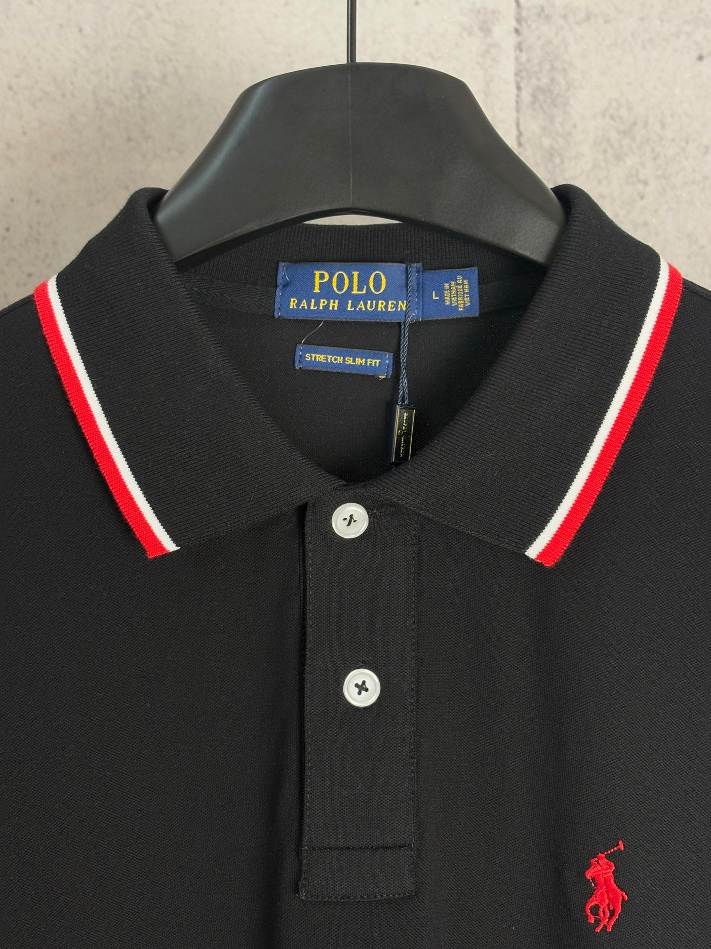 Black polo shirt with button placket, POLO Ralph Lauren tag, red pony logo
