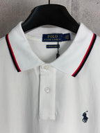 White polo shirt with red-and-navy striped collar and embroidered horse logo