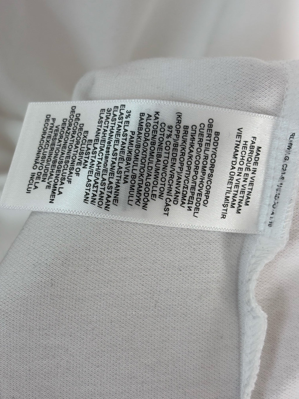 White polo shirt care label sewn inside