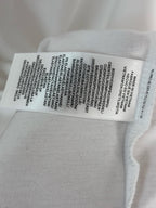 White polo shirt care label sewn inside