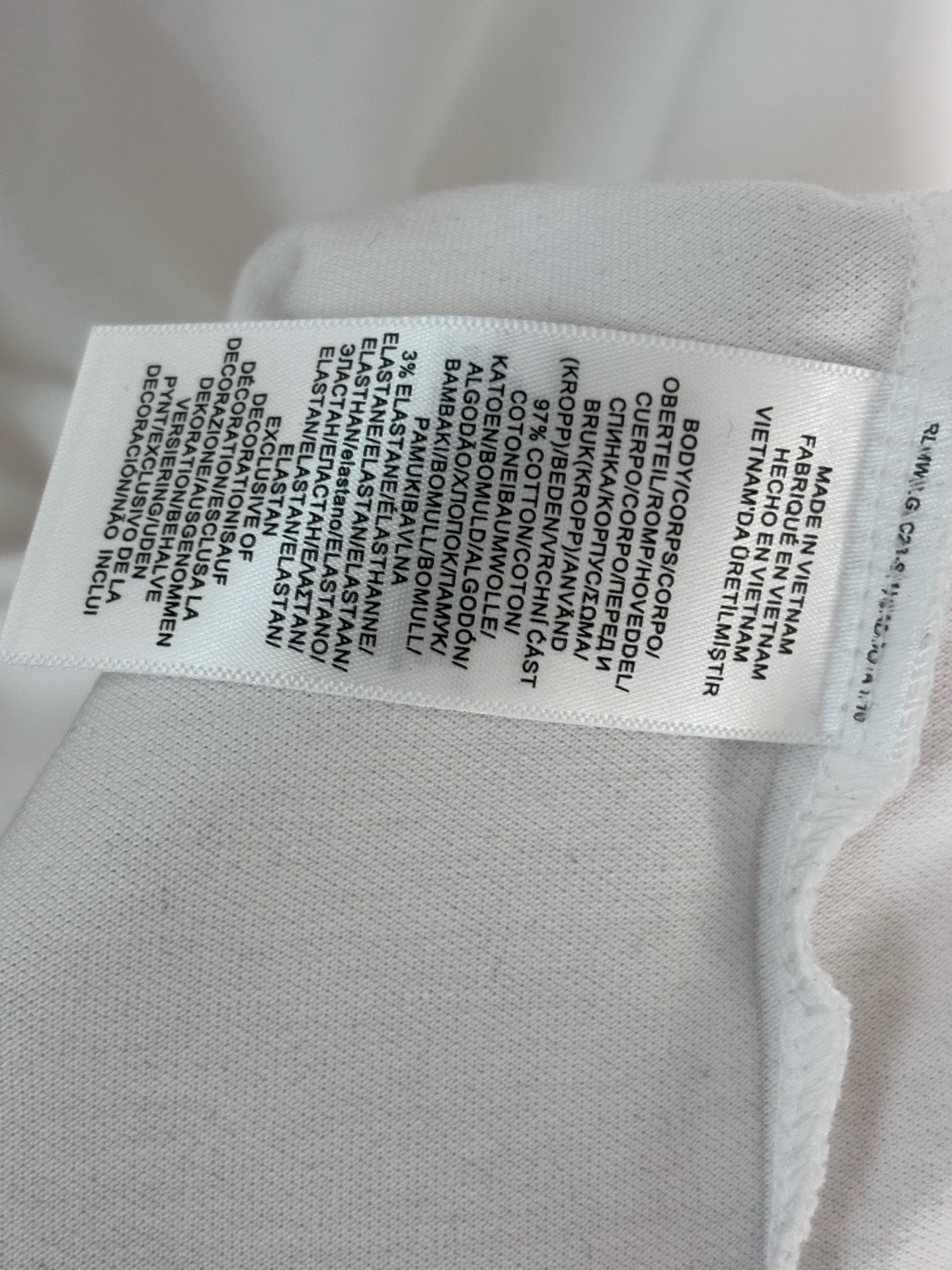 White polo shirt care label sewn inside