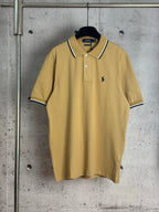 Polo shirt with short sleeves, button placket, and navy-trimmed collar