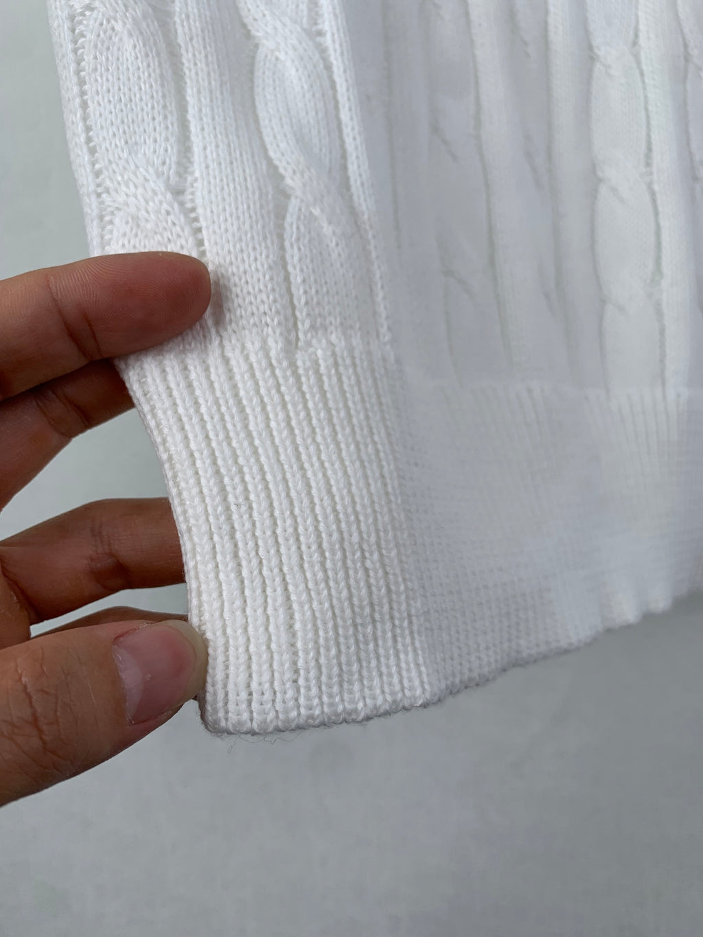 White cable-knit polo shirt ribbed hem with textured stitch detail