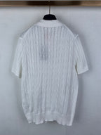 White cable-knit polo shirt with short sleeves and ribbed hem