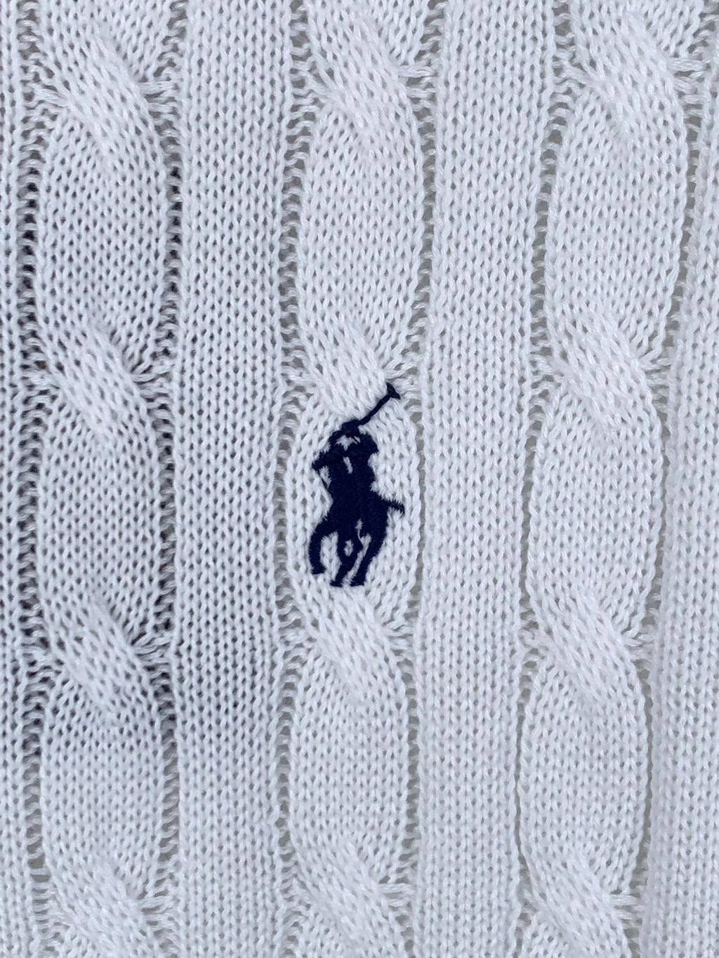White cable-knit polo shirt fabric with small embroidered pony logo